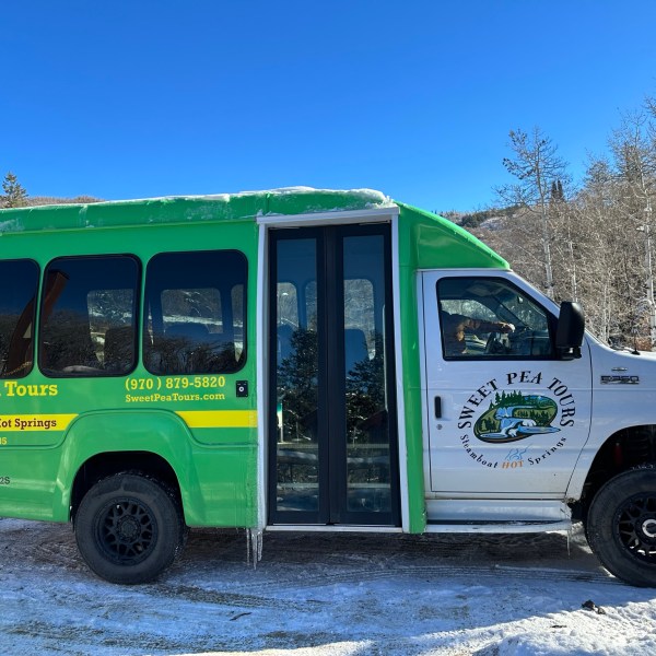 a green truck parked in a parking lot