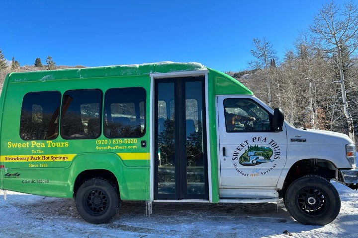 a green truck parked in a parking lot