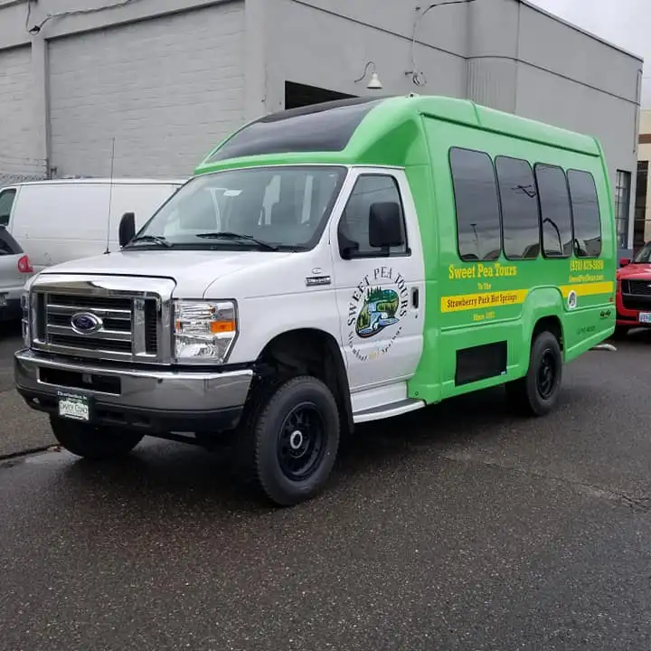 a green truck parked in a parking lot