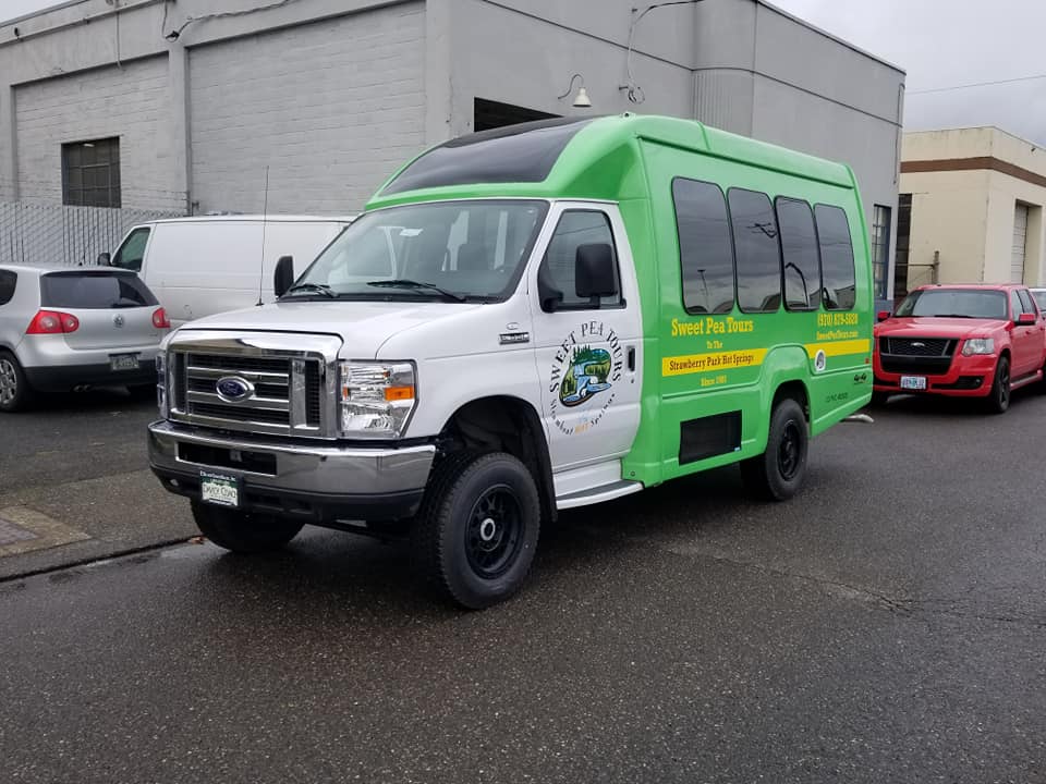 shuttle 1 a green truck parked in a parking lot